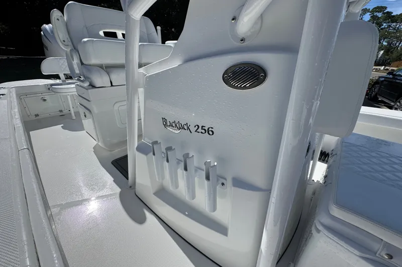 Slide: The Image of 2025 BlackJack 256 Coastal boat interior with seating and rod holders. - 24