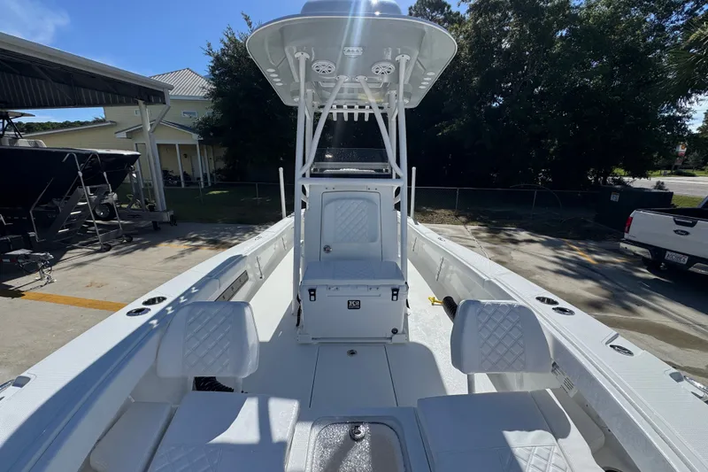 Slide: The Image of 2025 BlackJack 256 Coastal boat with white interior and seating, parked outdoors. - 21
