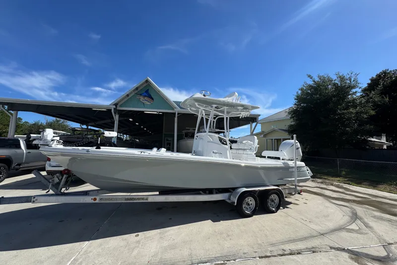 Slide: The Image of 2025 BlackJack 256 Coastal boat on trailer, parked outdoors under clear blue sky. - 2