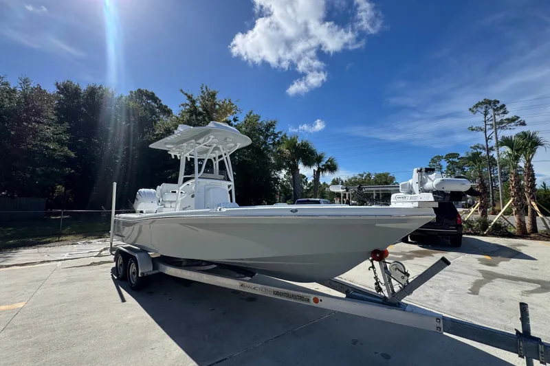 Slide: The Image of 2025 BlackJack 256 Coastal boat on trailer under clear blue sky. - 7