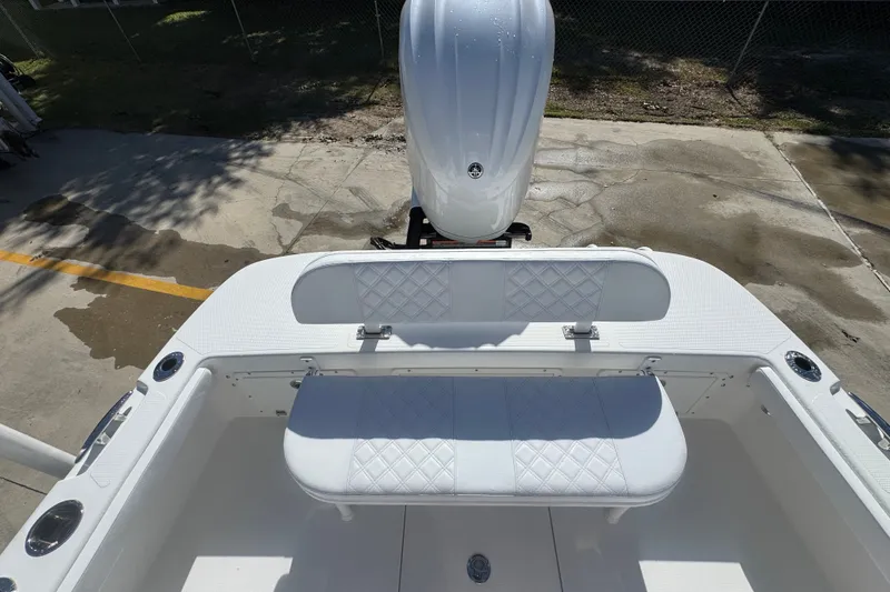 Slide: The Image of 2025 BlackJack 256 Coastal boat interior with white seating and engine view. - 40