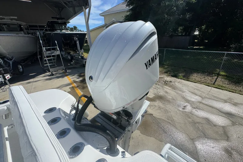 Slide: The Image of 2025 BlackJack 256 Coastal boat with Yamaha outboard engine in a sunny outdoor setting. - 42