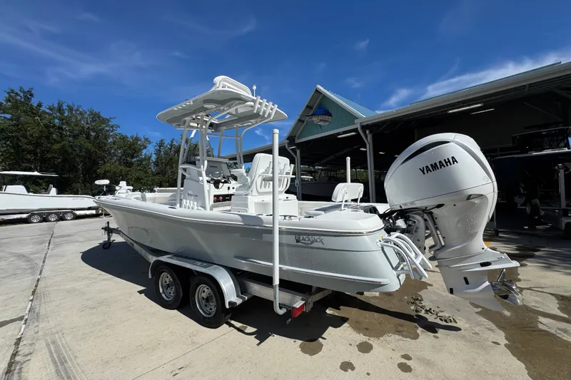 Slide: The Image of 2025 BlackJack 256 Coastal boat with Yamaha engine on a trailer, parked outdoors. - 14