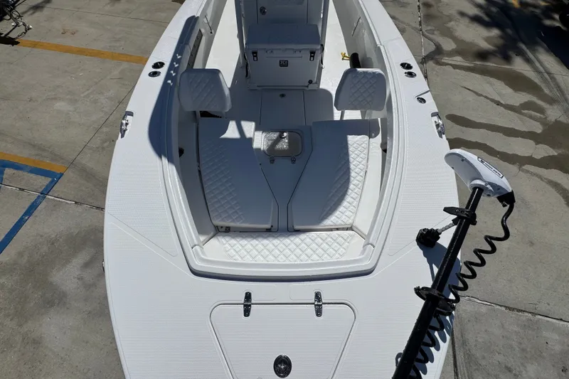 Slide: The Image of 2025 BlackJack 256 Coastal boat interior with white seating and trolling motor. - 19