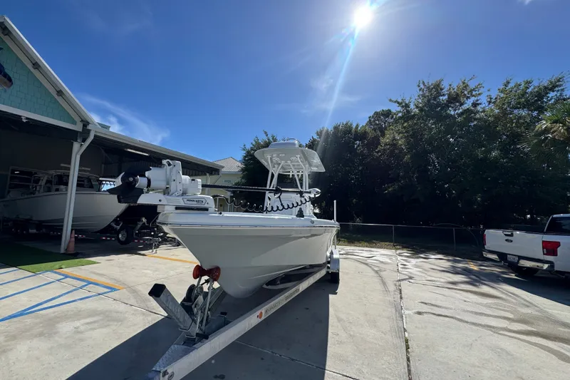 Slide: The Image of 2025 BlackJack 256 Coastal boat on trailer under sunny sky, parked near trees and buildings. - 5