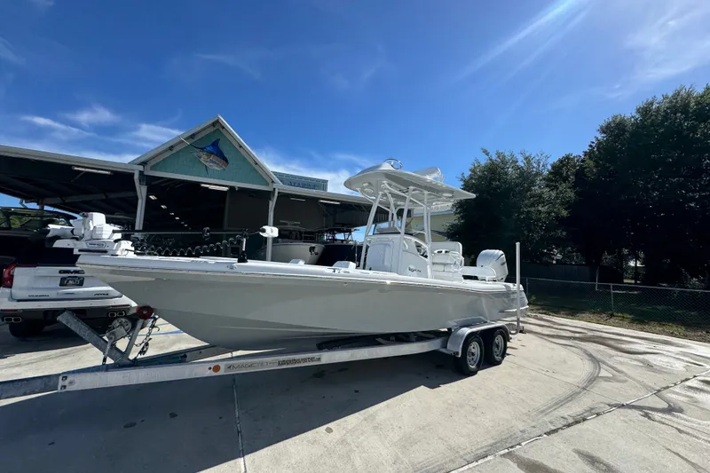 Slide: The Image of 2025 BlackJack 256 Coastal boat on trailer under clear blue sky. - 3