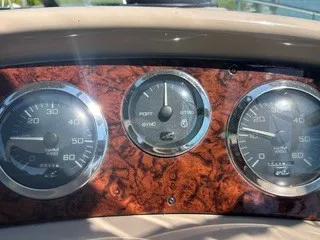 Slide: The Image of Dashboard with three round gauges on wood paneling. - 9