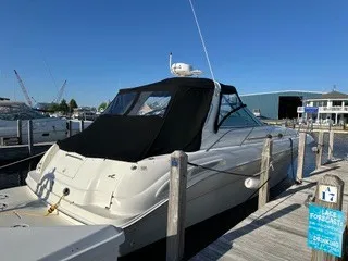 The Image of 1999 Sea Ray 410 Express Cruiser at dock with black canopy. - 6