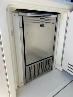 Slide: The Image of A stainless steel refrigerator is integrated into the boat's galley area. - 13