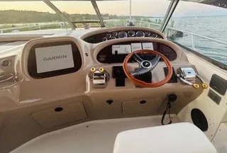 Slide: The Image of The cockpit of a 1999 Sea Ray 410 Express Cruiser featuring a Garmin navigation system. - 3