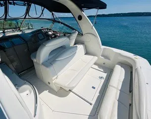 Slide: The Image of The image shows the cockpit of a 1999 Sea Ray 410 Express Cruiser with white seating and a blue canopy. - 4