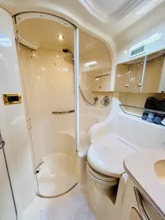Slide: The Image of The image shows a sleek boat bathroom with a shower, toilet, and sink. - 21