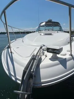Slide: The Image of A 1999 Sea Ray 410 Express Cruiser with a sleek white deck and stainless steel railing. - 7