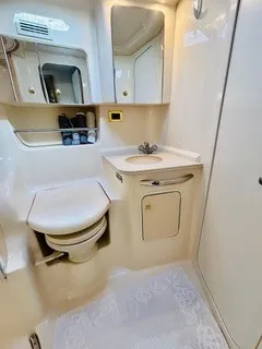Slide: The Image of The image shows a boat bathroom with a toilet, sink, and mirror. - 22