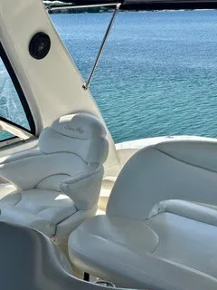 Slide: The Image of A sleek, white seating area on a boat overlooking the water. - 16