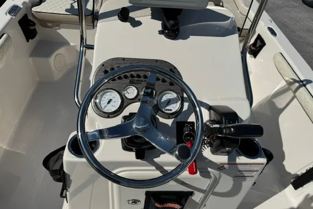 Slide: The Image of 2021 Carolina Skiff 19 LS boat dashboard with steering wheel and gauges. - 14
