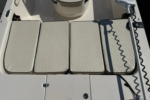 Slide: The Image of 2021 Carolina Skiff 19 LS boat interior with cushioned seating and trolling motor. - 9