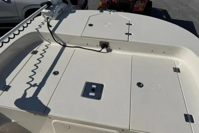 Slide: The Image of 2021 Carolina Skiff 19 LS boat deck with storage compartments and trolling motor. - 19