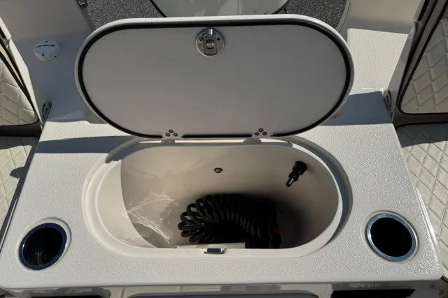 Slide: The Image of Open storage compartment on 2021 Carolina Skiff 19 LS boat with coiled hose inside. - 15