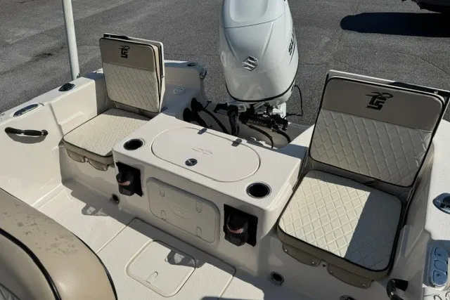 Slide: The Image of 2021 Carolina Skiff 19 LS boat interior with seating and Suzuki outboard motor. - 16
