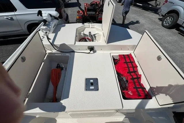 Slide: The Image of 2021 Carolina Skiff 19 LS boat with open storage compartments and safety equipment. - 18