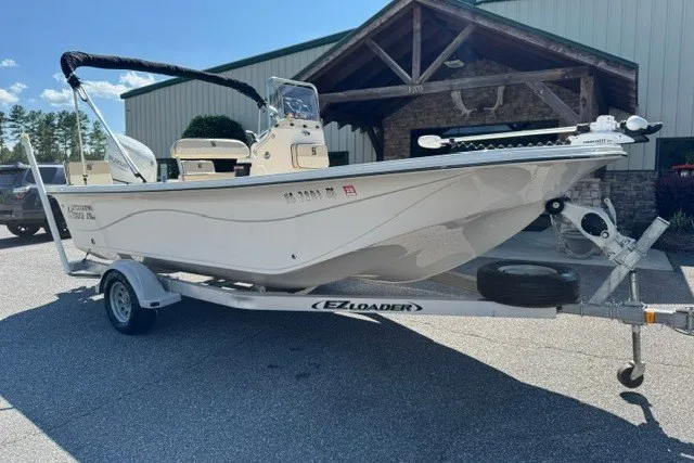 Slide: The Image of 2021 Carolina Skiff 19 LS boat on EZ Loader trailer, parked outdoors. - 2