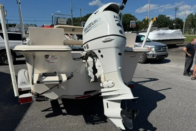 Slide: The Image of 2021 Carolina Skiff 19 LS boat with Suzuki outboard motor in a parking lot. - 6