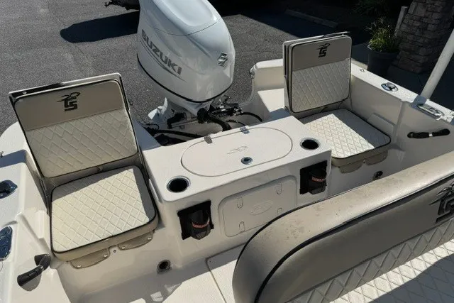 Slide: The Image of 2021 Carolina Skiff 19 LS boat interior with Suzuki outboard motor and cushioned seating. - 12