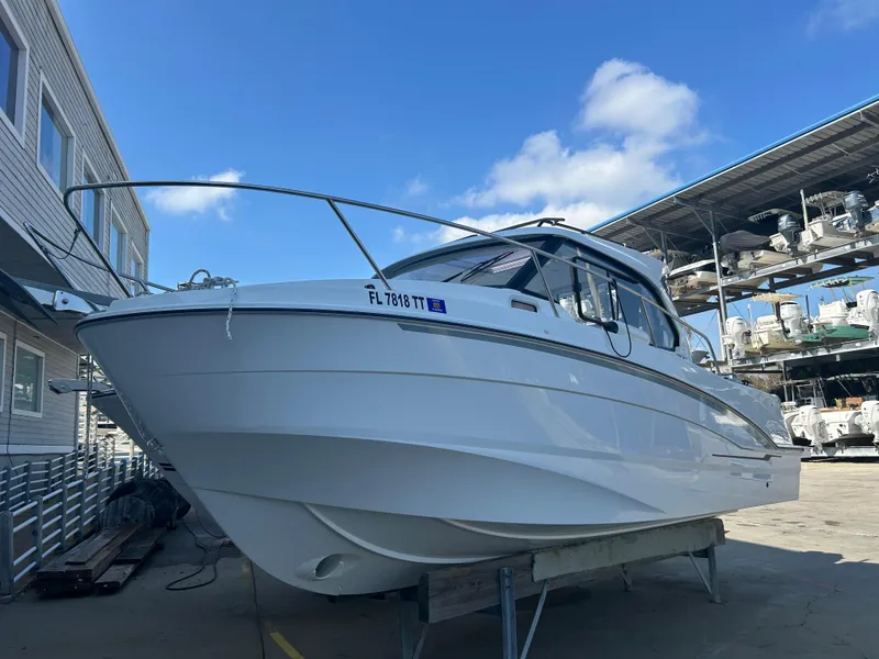 Slide: The Image of 2024 Beneteau Antares 8 boat on display in a marina setting. - 1