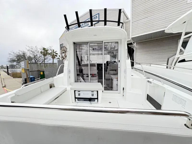 Slide: The Image of 2024 Beneteau Antares 8 boat, rear view with open deck and sliding doors. - 5
