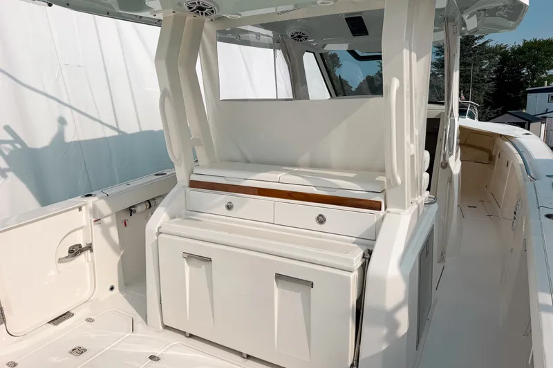 Slide: The Image of 2027 Pursuit S 328 Sport boat interior with sleek white seating and storage compartments. - 6