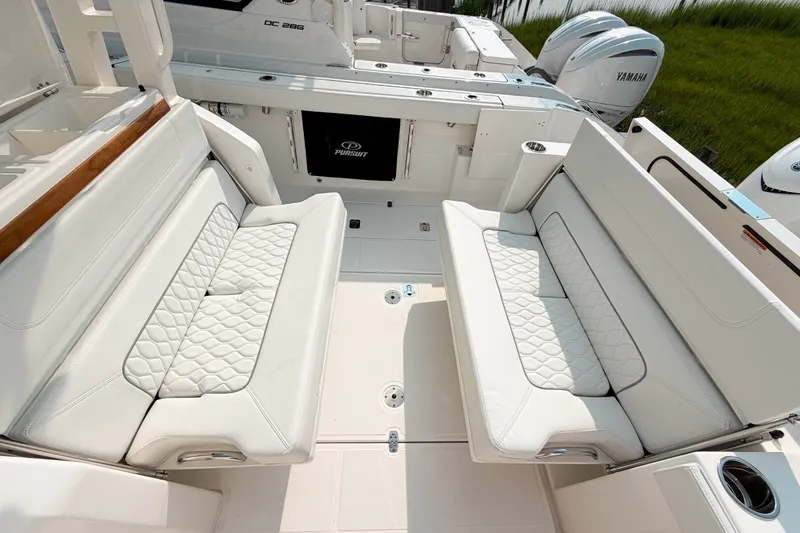 Slide: The Image of 2027 Pursuit S 328 Sport boat interior with luxurious white seating and Yamaha engines. - 12