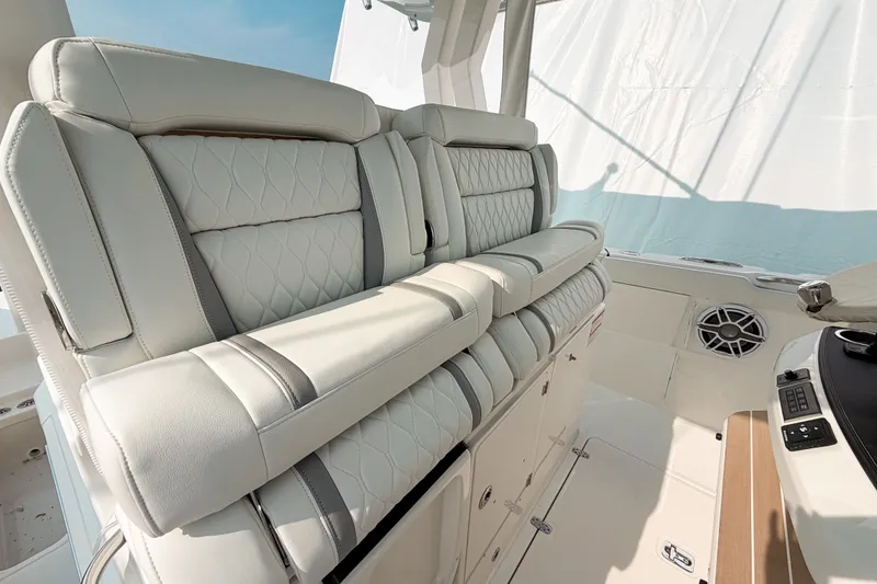 Slide: The Image of Luxurious seating on 2027 Pursuit S 328 Sport boat, featuring elegant white upholstery. - 14