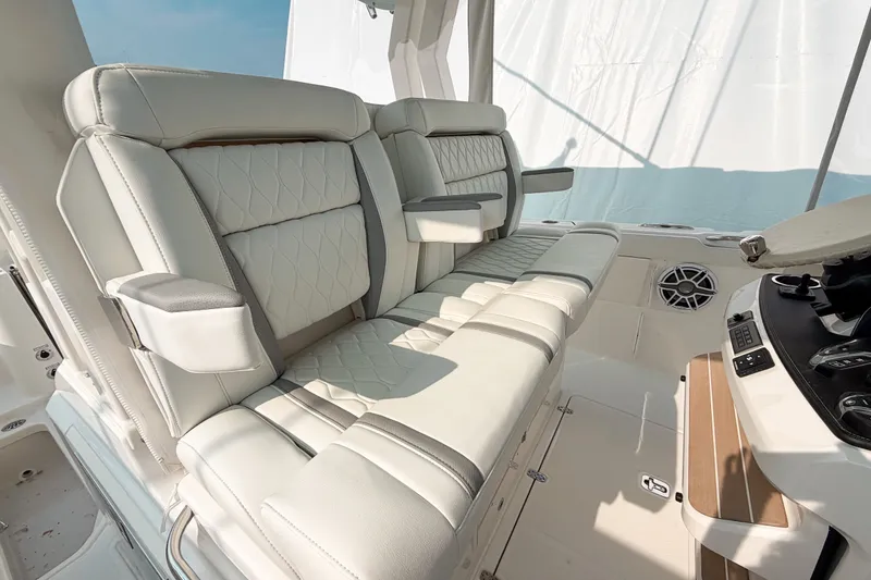 Slide: The Image of Luxurious seating on 2027 Pursuit S 328 Sport boat, featuring elegant white upholstery and modern design. - 15