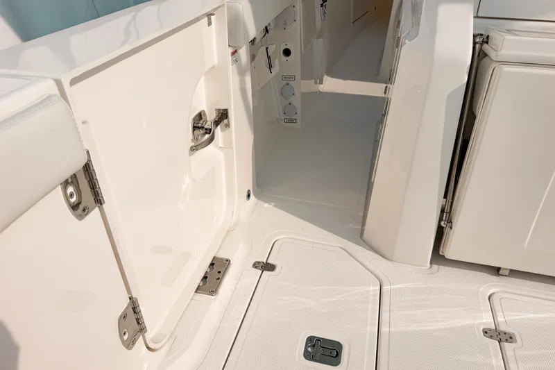Slide: The Image of 2027 Pursuit S 328 Sport boat interior, featuring open storage compartments and sleek design. - 13