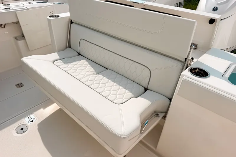 Slide: The Image of Luxury seating on 2027 Pursuit S 328 Sport boat with quilted upholstery and cup holder. - 11