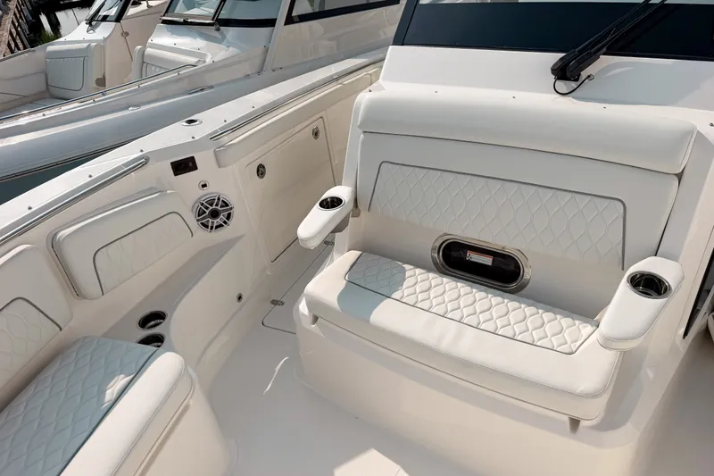 Slide: The Image of Luxurious seating on the 2027 Pursuit S 328 Sport boat, featuring elegant white upholstery. - 21