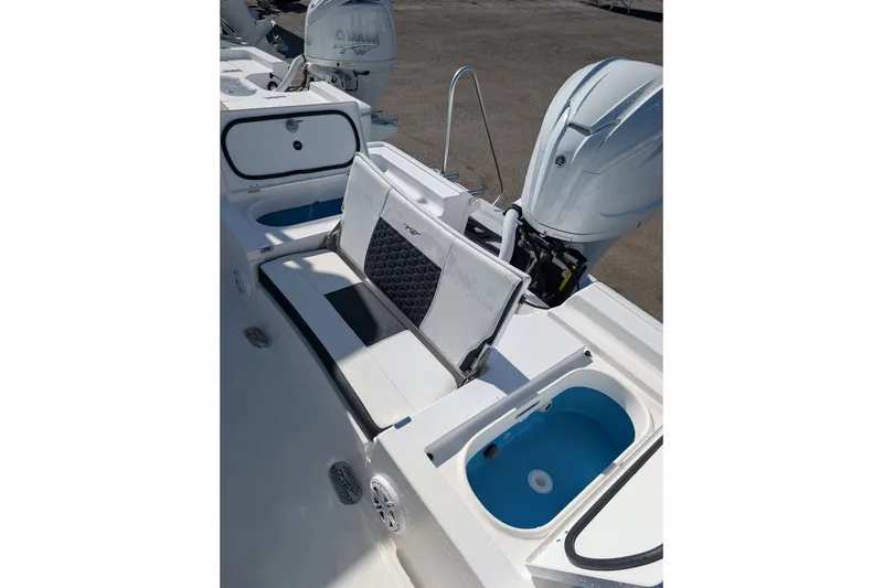 Slide: The Image of 2027 Tidewater 2500 Carolina Bay boat interior with seating and storage compartments. - 6