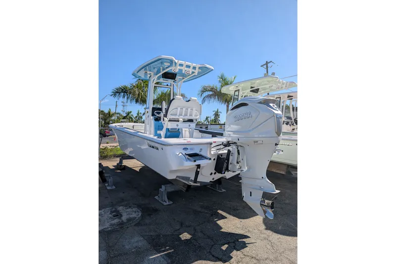 Slide: The Image of 2027 Tidewater 2500 Carolina Bay boat with Yamaha engine, parked outdoors. - 1