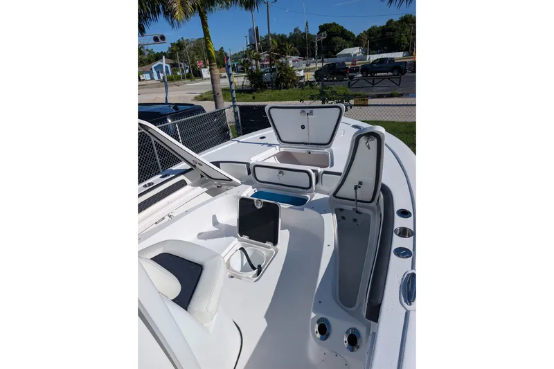 Slide: The Image of 2027 Tidewater 2500 Carolina Bay boat interior with open storage compartments and seating. - 11