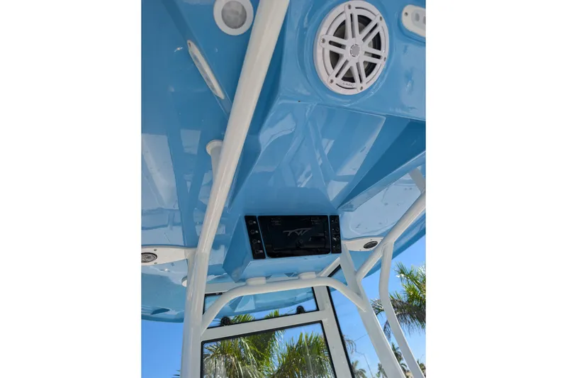 Slide: The Image of 2027 Tidewater 2500 Carolina Bay boat interior with blue ceiling and speaker system. - 9