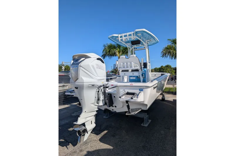 Slide: The Image of 2027 Tidewater 2500 Carolina Bay boat with Yamaha outboard motor, parked outdoors. - 2