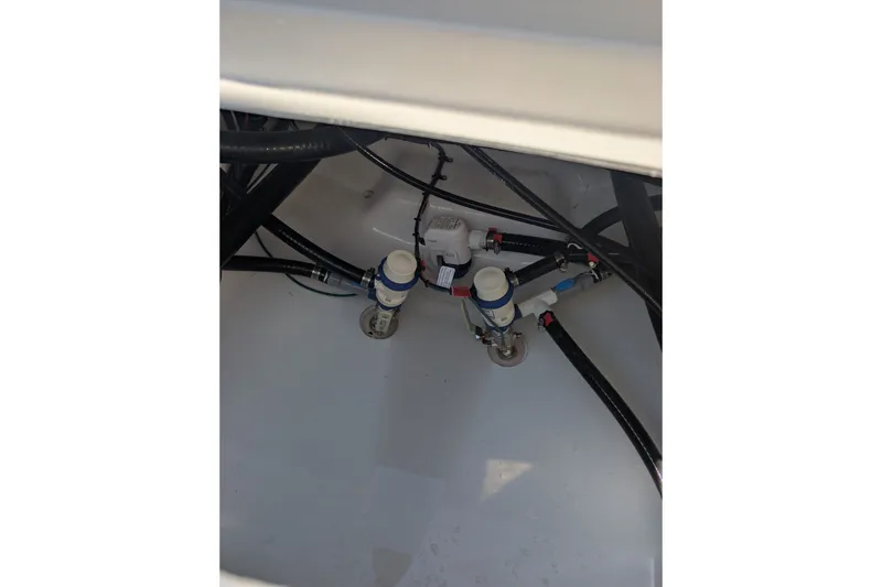 Slide: The Image of Bilge area of 2027 Tidewater 2500 Carolina Bay boat with visible plumbing and wiring. - 15