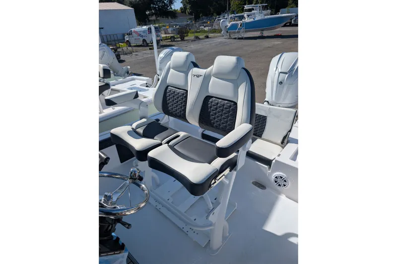 Slide: The Image of 2027 Tidewater 2500 Carolina Bay boat with dual cushioned seats and steering wheel. - 7