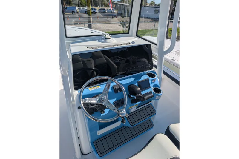 Slide: The Image of 2027 Tidewater 2500 Carolina Bay boat console with steering wheel and controls. - 8