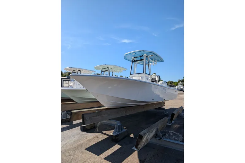The Image of 2027 Tidewater 2500 Carolina Bay boat on display under clear blue sky. - 0