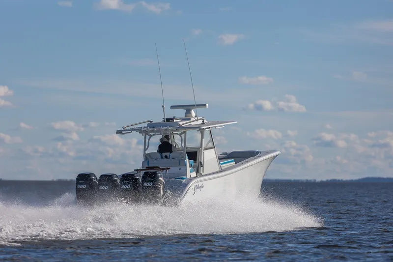 Slide: The Image of 2018 Yellowfin 39 Offshore boat cruising on open water under a clear sky. - 25