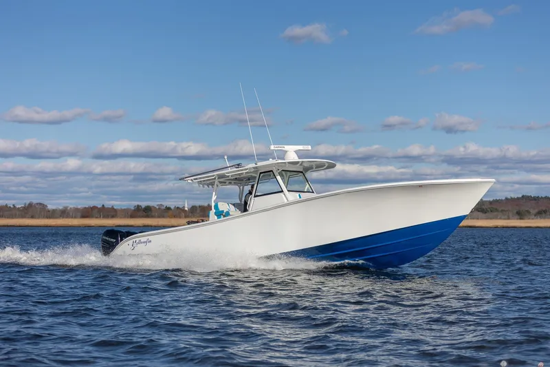 Slide: The Image of 2018 Yellowfin 39 Offshore boat cruising on open water under a clear blue sky. - 32