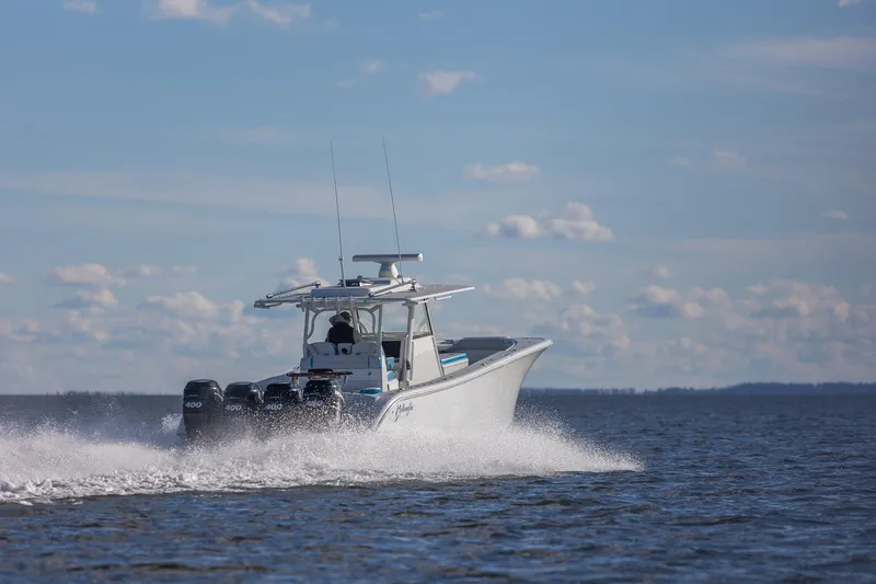 Slide: The Image of 2018 Yellowfin 39 Offshore boat cruising on open water under a clear sky. - 26