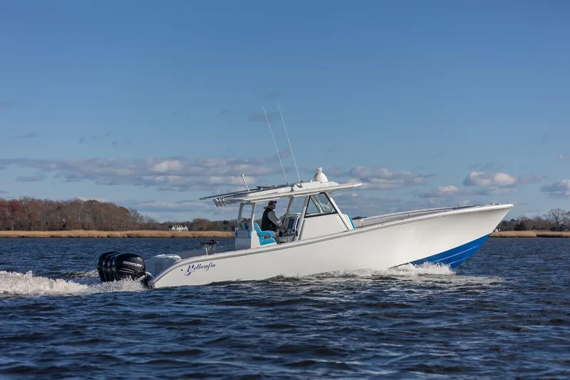 Slide: The Image of 2018 Yellowfin 39 Offshore boat cruising on a calm waterway under a clear blue sky. - 30